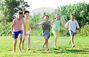 Barefoot kids running on green grass