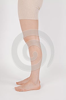 Barefoot and legs isolated on white background. Closeup shot of healthy beautiful female feet. Health and beauty concept