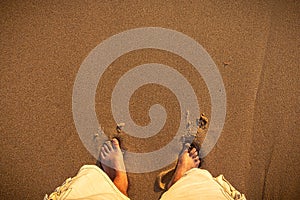 A barefoot man on the beach