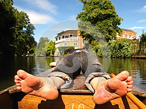 Barefoot man on boat Oxford England punting