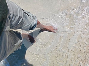 Barefoot of A Man Enjoying White Sand Beach During Holiday Season in A Hot Summer Day