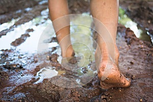 Barefoot through muddy road