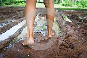 Barefoot through muddy road