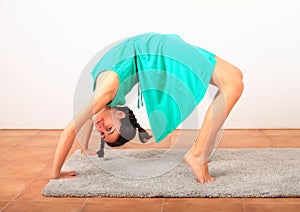 Pretty girl exercising yoga - wheel pose