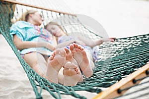 Barefoot and Relaxed family napping in a hammock together photo