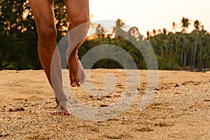 Barefoot running on beach at sunset