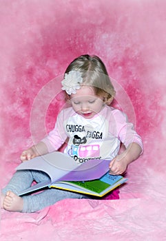 Barefoot toddler and colorful picture  book