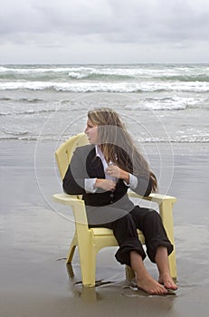 Barefoot Woman in Chair Looking Out To Sea