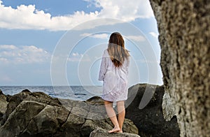 Barefoot woman enjoying the solitude of the coast