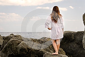 Barefoot woman enjoying the solitude of the coast