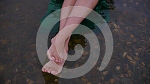 Barefoot woman enjoying the splashing of waves on the water, relaxing by the sea in summer, vacation, freedom, lifestyle