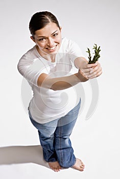 Barefoot woman holding fresh herbs