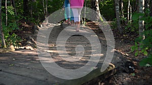 Barefoot woman and kids walking through on healthy sensory path.