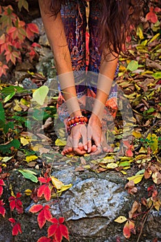 Barefoot woman legs and hands in yoga stretch pose in colorful