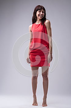 Barefoot woman in red acts youthfully photo