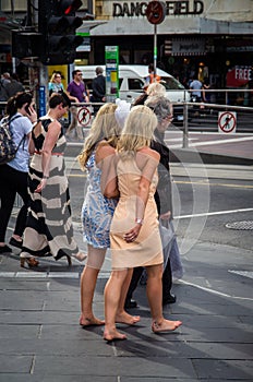 Barefoot woman returning from Melbourne Cup