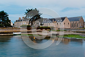 Historic stone houses in typical architectural style of Normandy and harbor in Barfleur