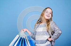 Bargain sale. Kid fashion. shop assistant with package. Sales and discounts. Small girl with shopping bags. Happy child