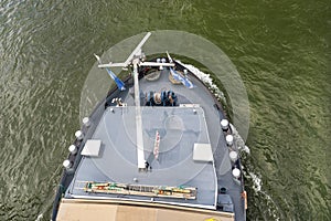 A barge carrying coal with a covered hold on the River Rhine in Germany. Transport of coal and solid fuel, view from above.