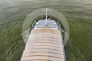 A barge carrying coal with a covered hold on the River Rhine in Germany. Transport of coal and solid fuel, view from above.