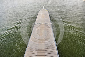 A barge carrying coal with a covered hold on the River Rhine in Germany. Transport of coal and solid fuel, view from above.