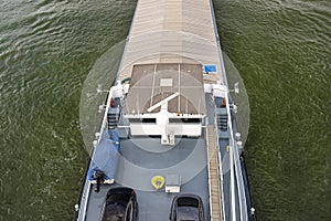 A barge carrying coal with a covered hold on the River Rhine in Germany. Transport of coal and solid fuel, view from above.