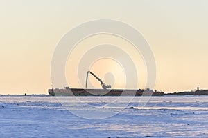 Barge with crane. Dredger working at sea. Sunset in Arctic sea. Construction Marine offshore works. Dam building, crane, barge,