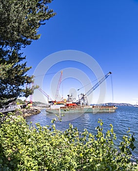 Barge with cranes on Elliott Bay on summer day