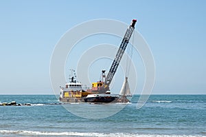 Barge dredging a harbor