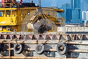 Barge dredging a harbor