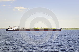 The barge floats along the river