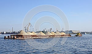 Barge loaded with sand on the river