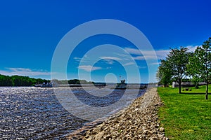 A Barge passes the cassville car ferry on the mississippi river