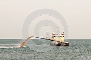 Barge Pipe pushing sand onto the beach