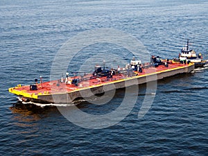 Barge pushed by a tugboat