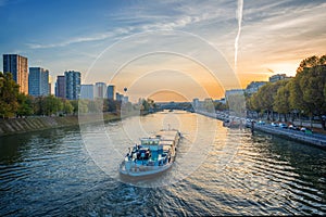 Barge on the river Seine at sunset, Paris France