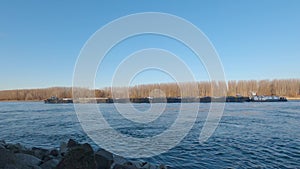 Barge runs on the water along the Danube river separating Hungary and Slovakia.