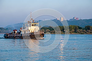 A barge sailing along the Volga River at sunset.