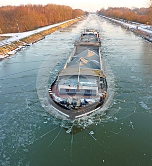 A barge sailing on frozen river