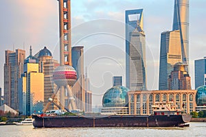 Barge by sunset Shanghai skyline
