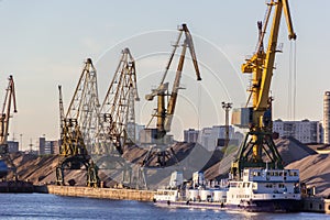 Barges and cranes in river port