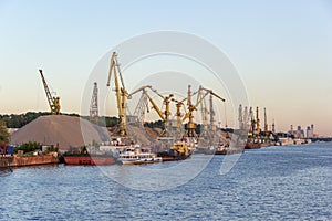 Barges and cranes in river port