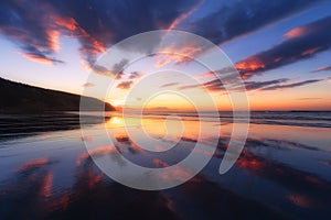 Barinatxe beach with cloud reflections at sunset