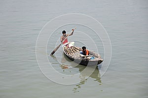 Barisal, Bangladesh, February 28 2017: Two fishermen row in their small boat