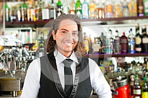 Barista or barman behind his bar