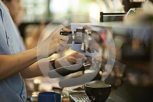 Barista cafe making fresh coffee by machine