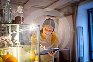 Barista checking desserts in the display case