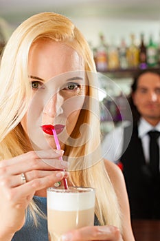 Barista with client in his cafe or coffeeshop