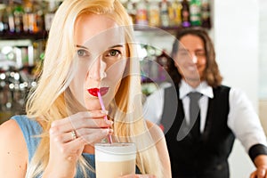 Barista with client in his cafe or coffeeshop