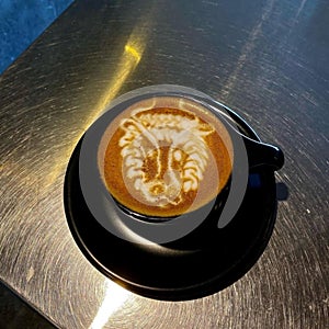 Barista coffee latte art on black pirch cup